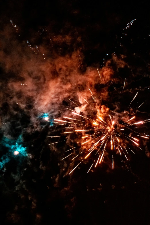 fireworks going off during a festival in the dark