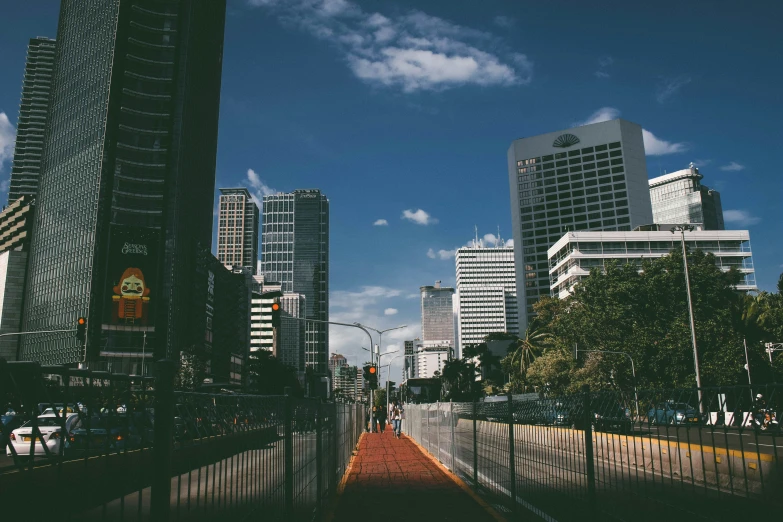 a city street lined with tall buildings and gates