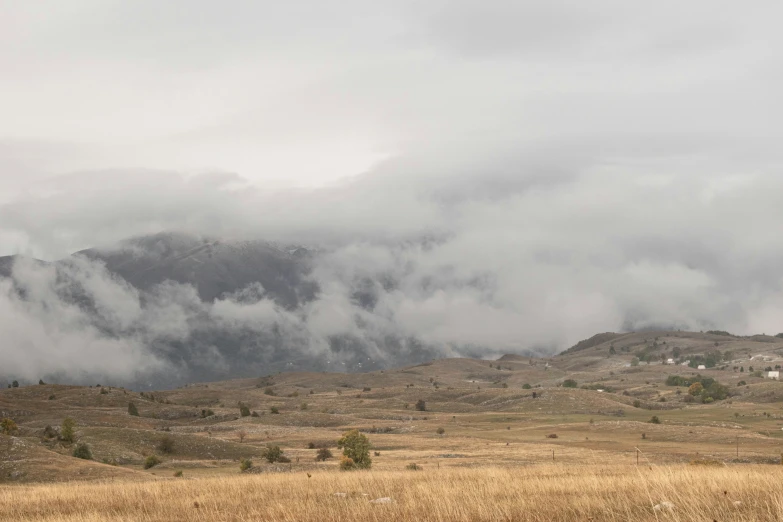 the mountain is very high with a bunch of clouds