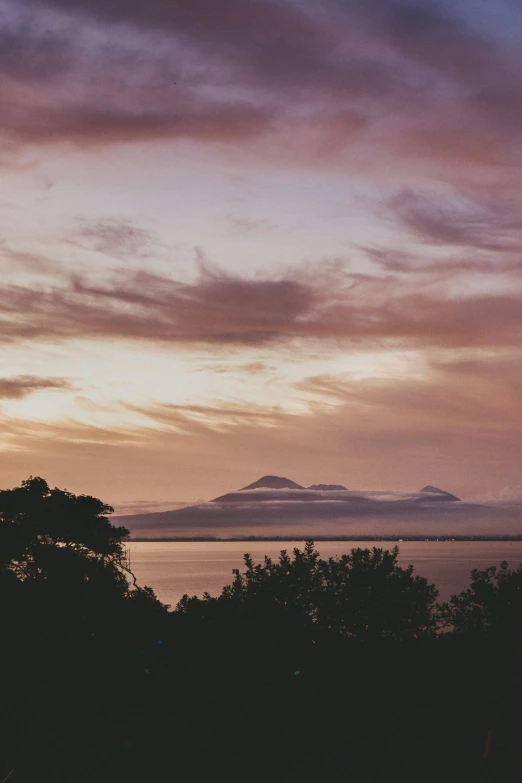 a picture of a sunset with mountains in the background