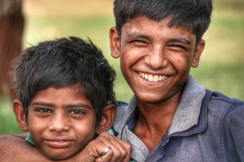 two children standing side by side smiling for the camera