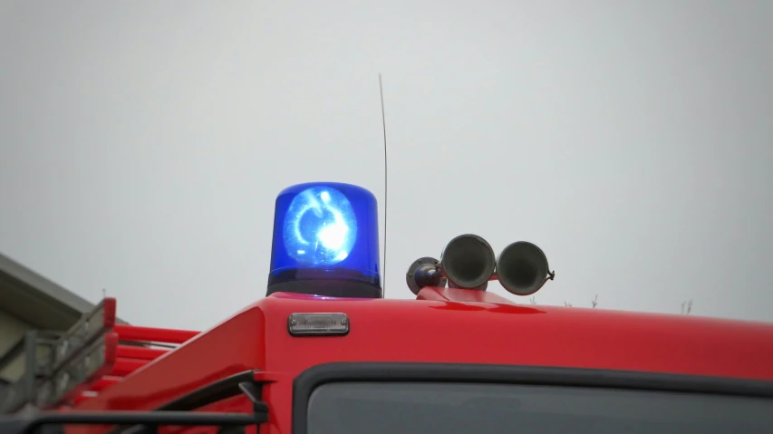 a traffic light on the back of a red vehicle