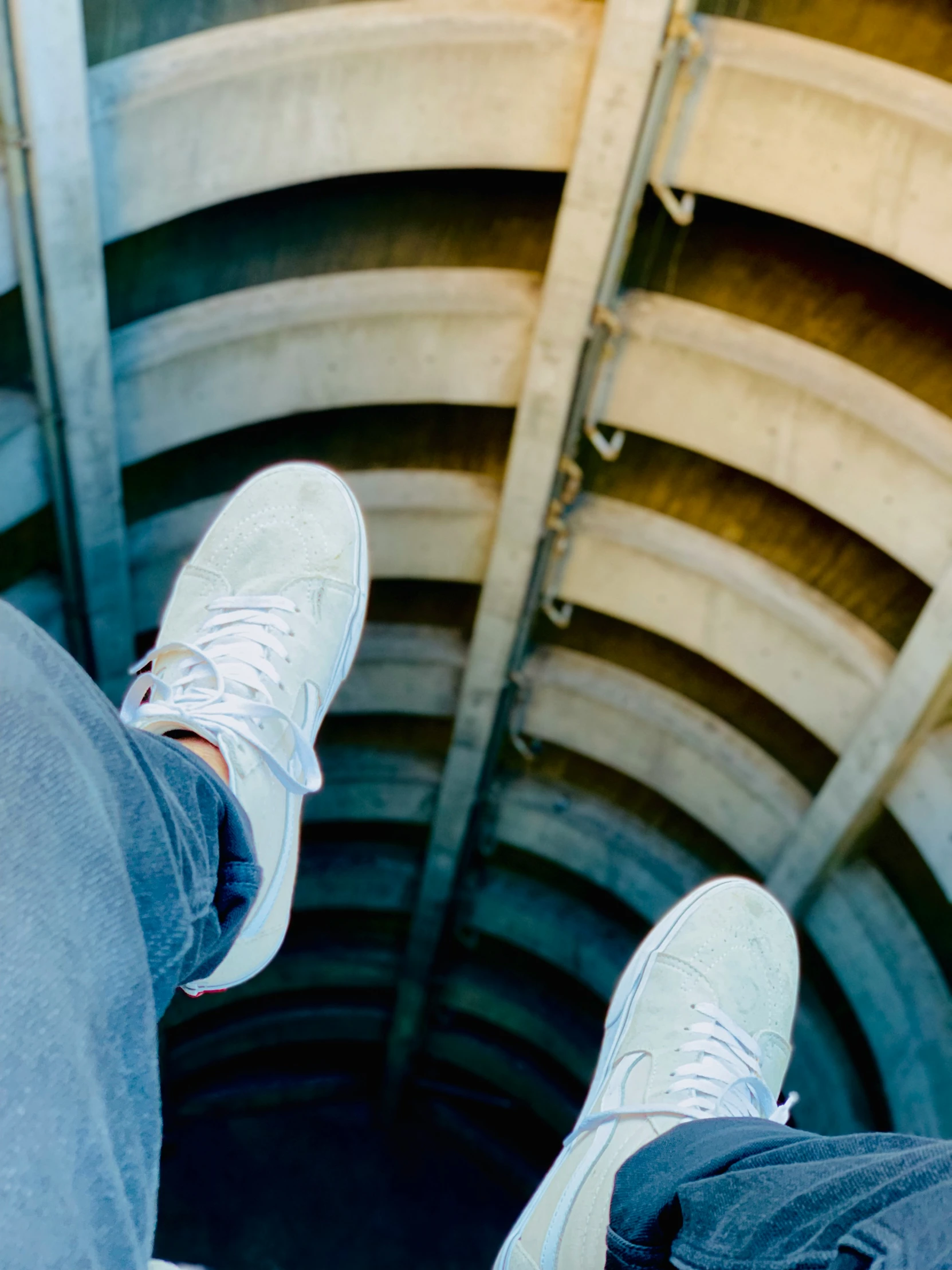 a pair of feet standing in an open looking structure