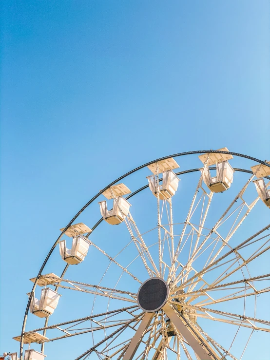 a ferris wheel in front of the blue sky