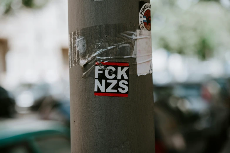 a sticker on the side of a pole with a tag