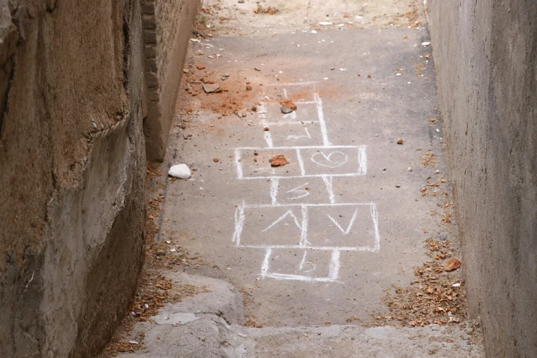 an alley way with some graffiti on the cement