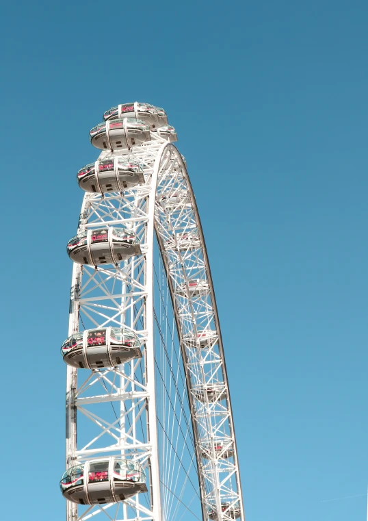 a ferris wheel with cars in the top section of the ferris wheel