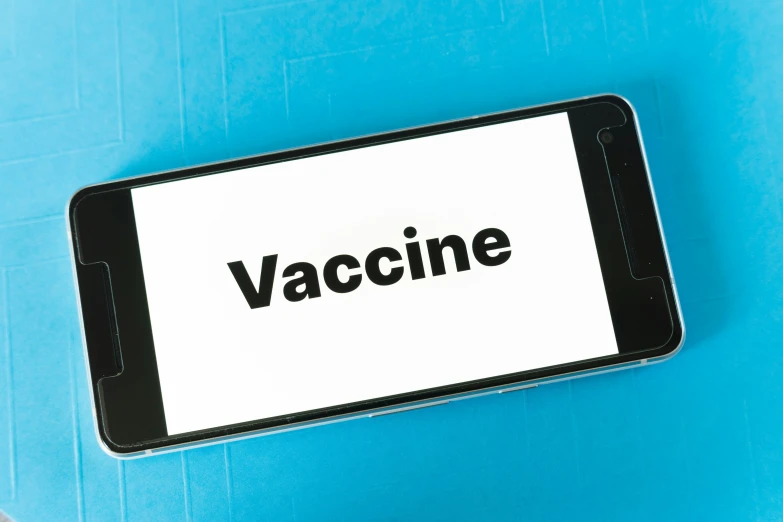 a cell phone with the words vaccine written on it