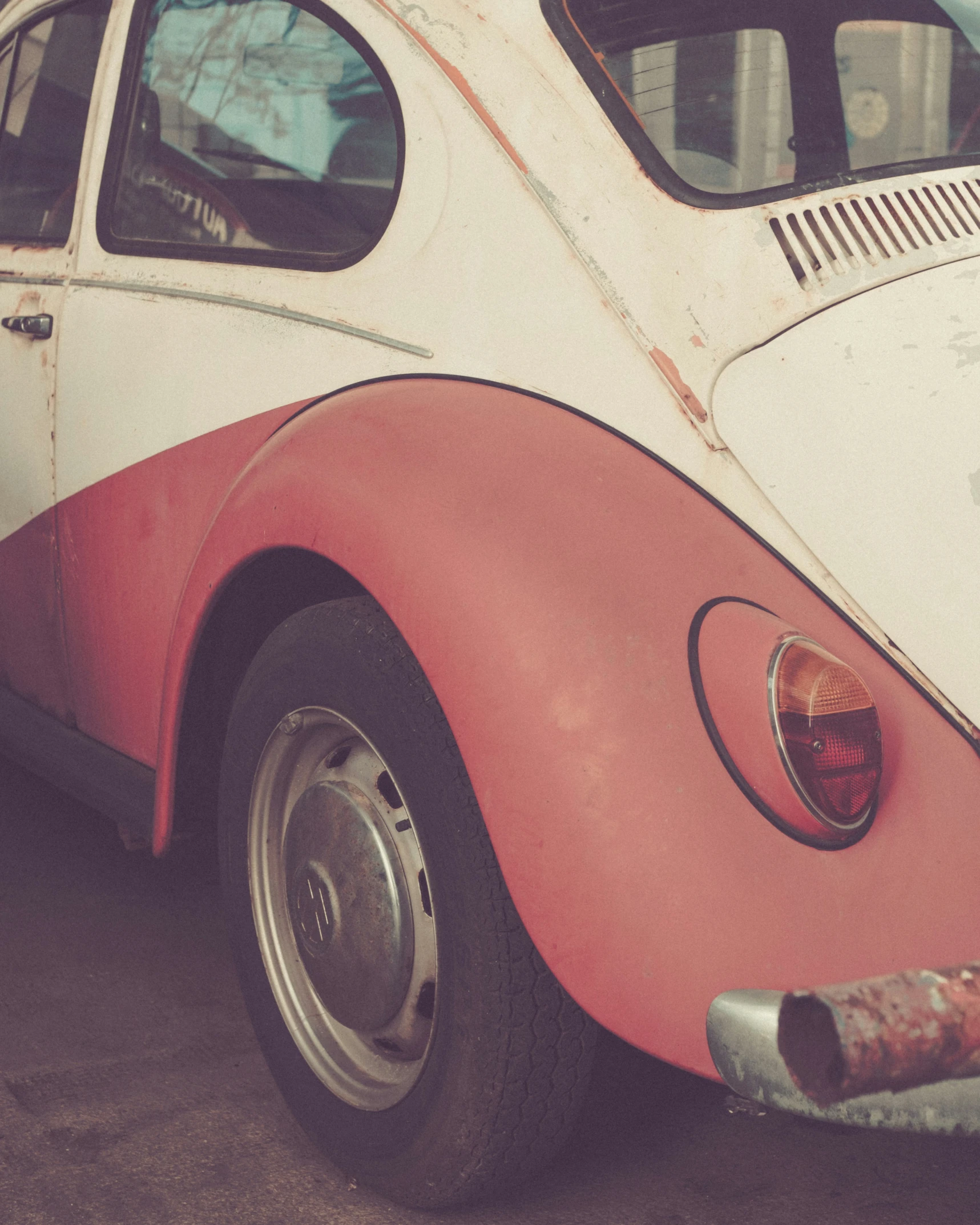 a car sits in front of another vehicle in the background