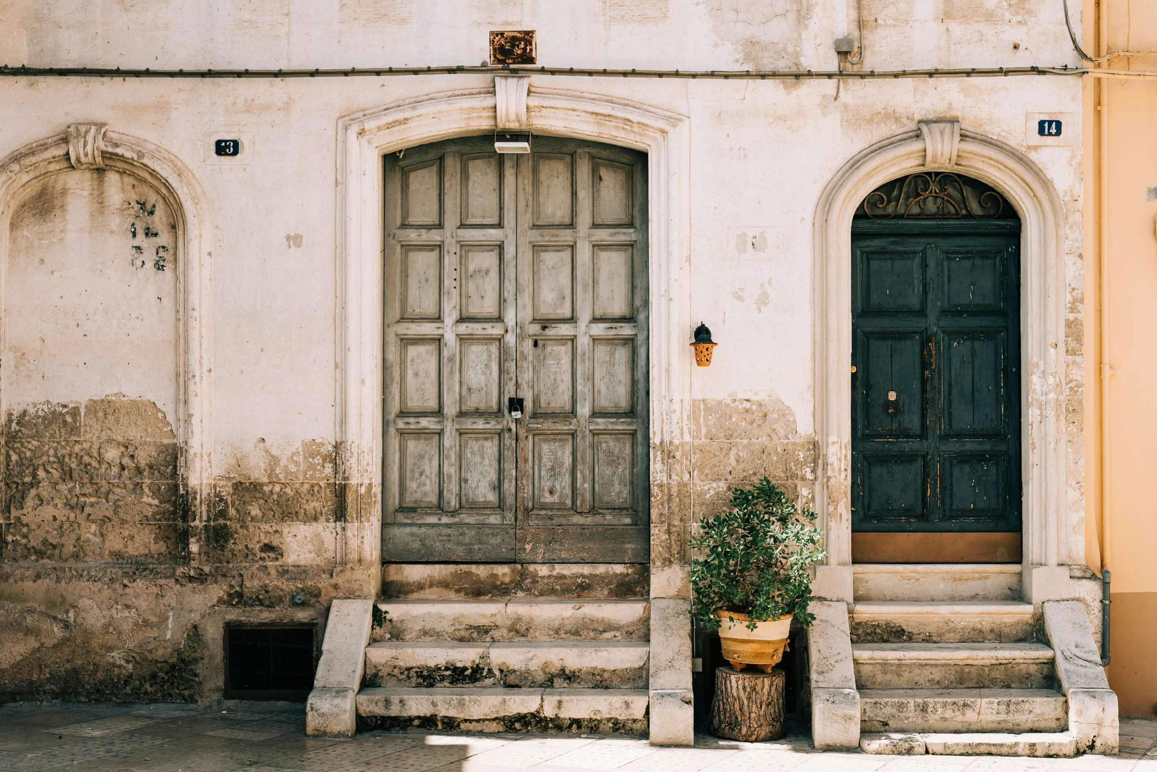 two doors with frames on an old building