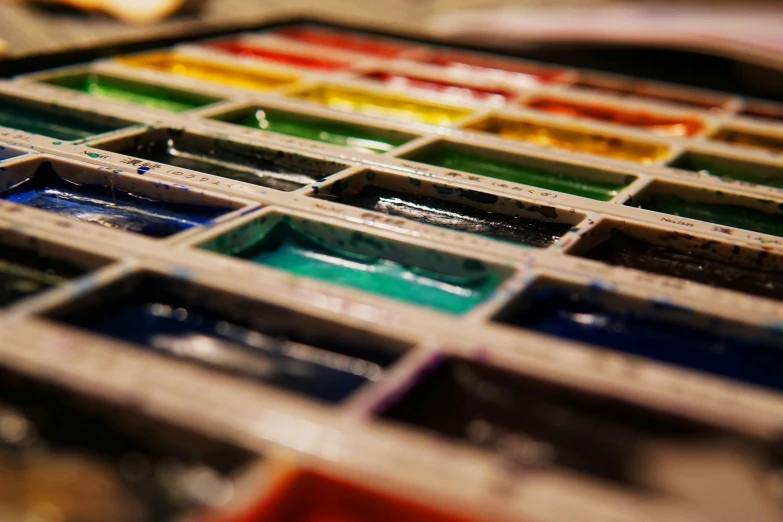 a close up of an artistic art palette of various color