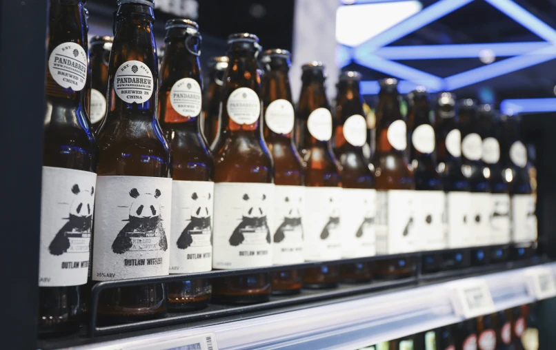 the shelf with various bottles of beer on display