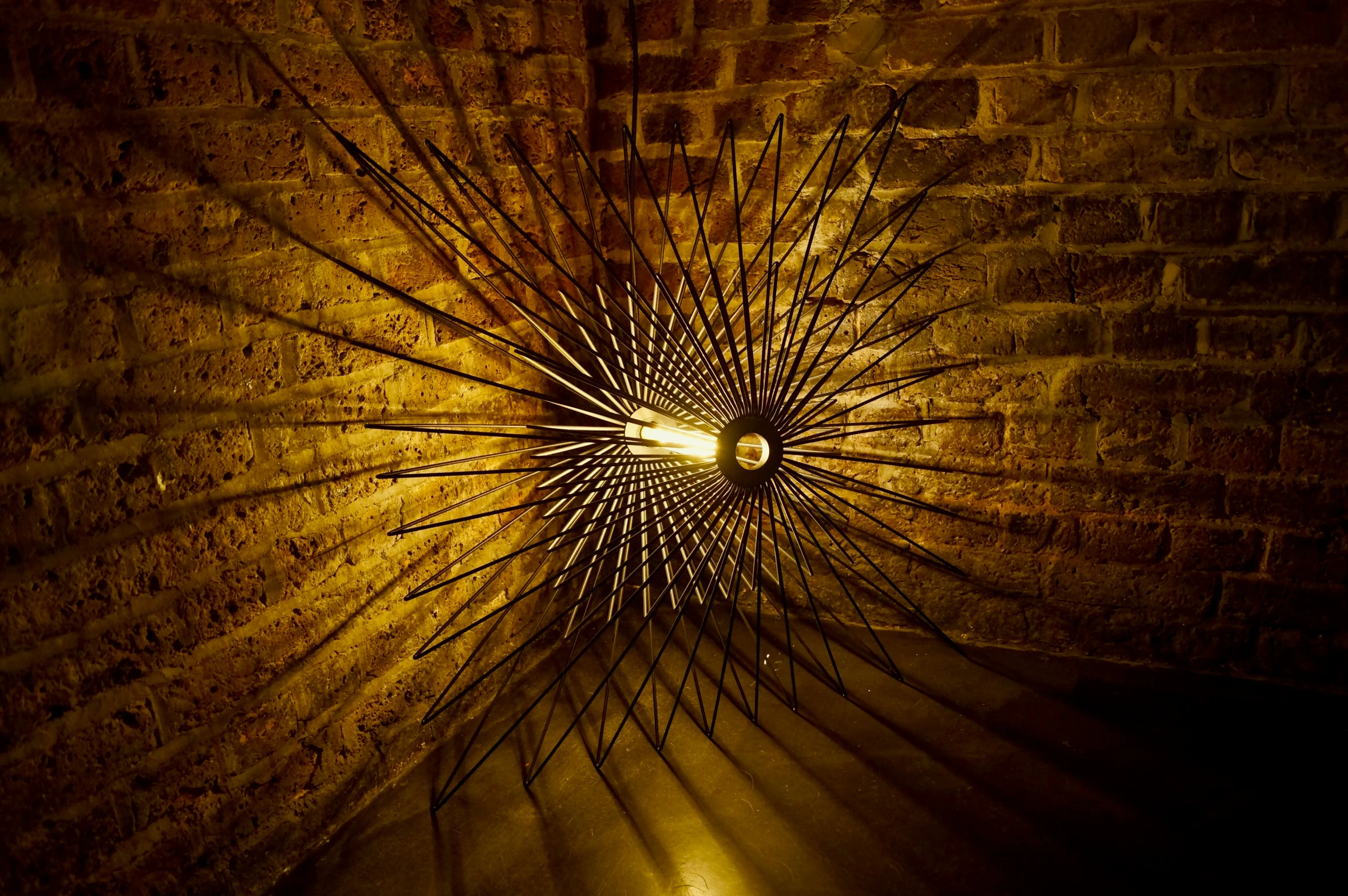 an illuminated lamp shining on the ground in a dimly lit room