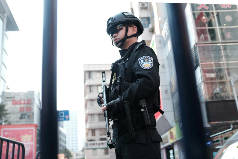 a police officer standing next to a tall building