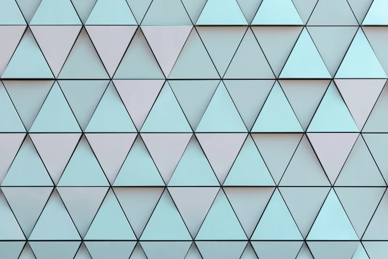 many triangles on a gray wall with blue paint