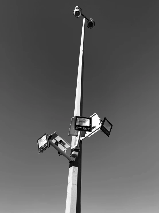 this is a camera and television on the top of a light pole