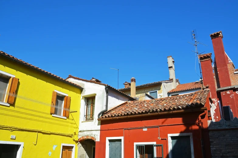 a row of buildings with red brick roof tops