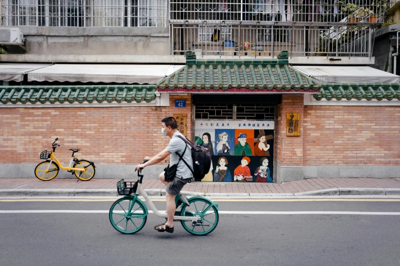 a person riding a bicycle on a city street