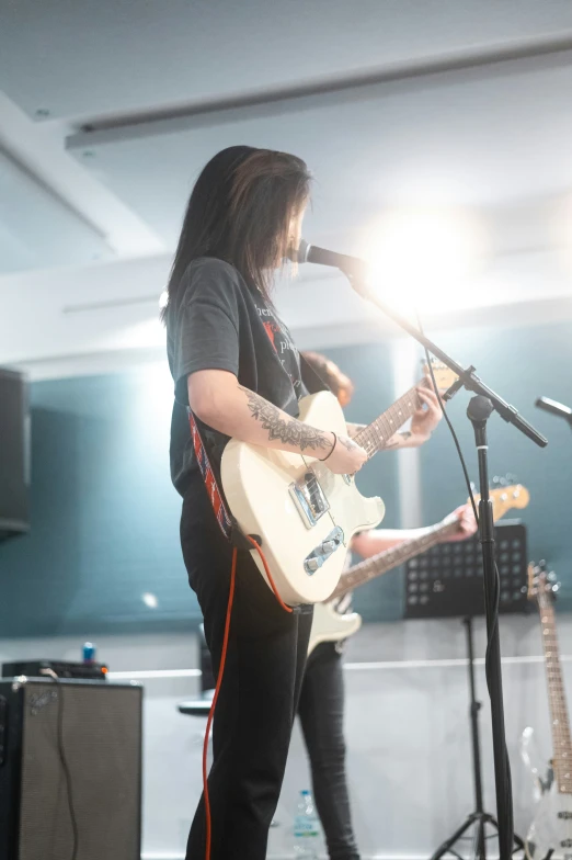 a person playing a guitar on a stage