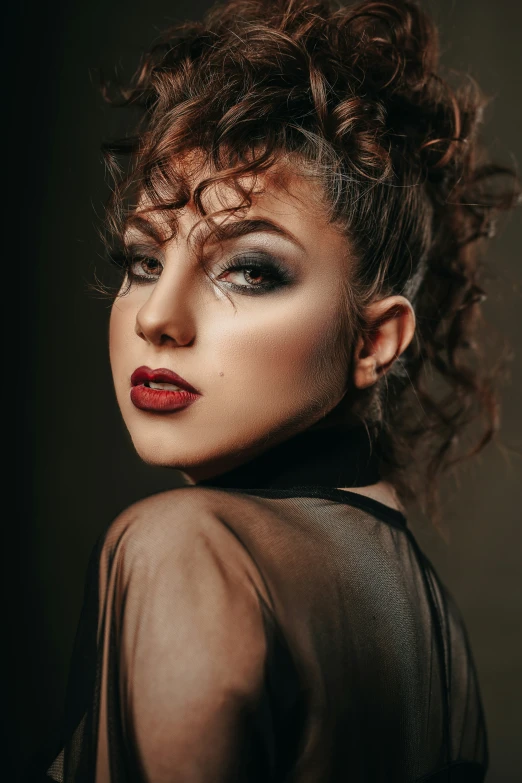 a woman with curly hair is posing