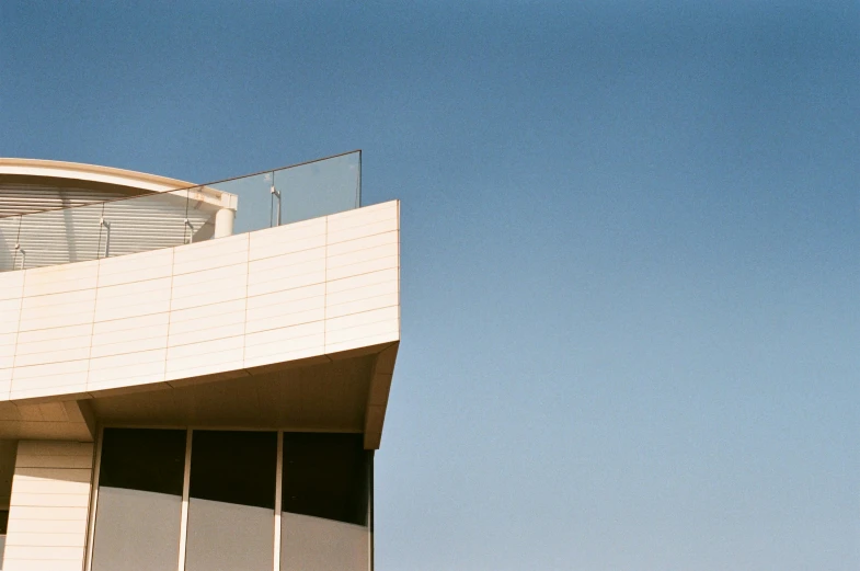 the top of a building with glass balconies