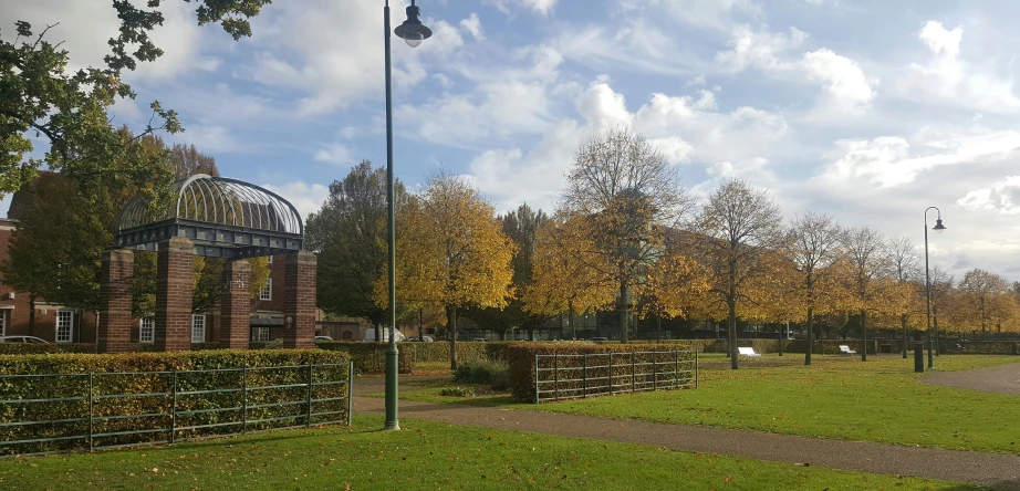 a brick building in the foreground and a green field in the background