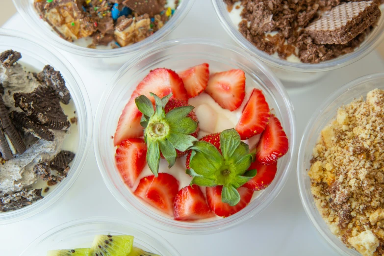 a tray of various types of food including kiwi, strawberries and cereal