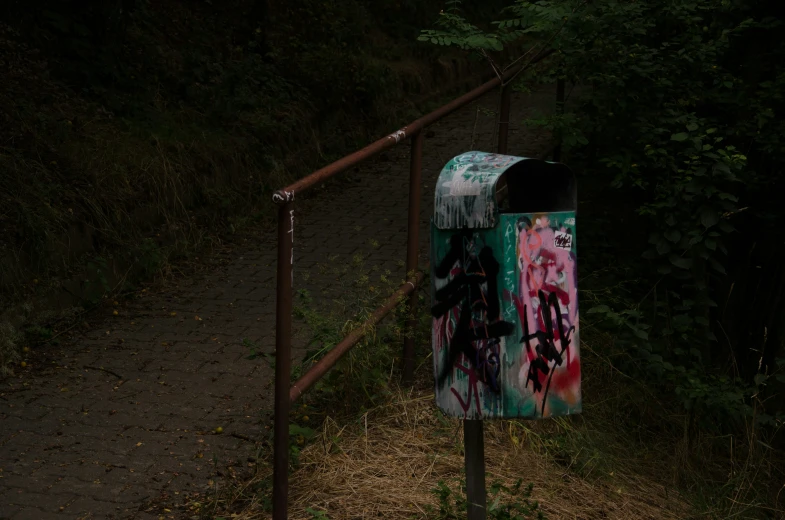 a trash can that has some graffiti on it