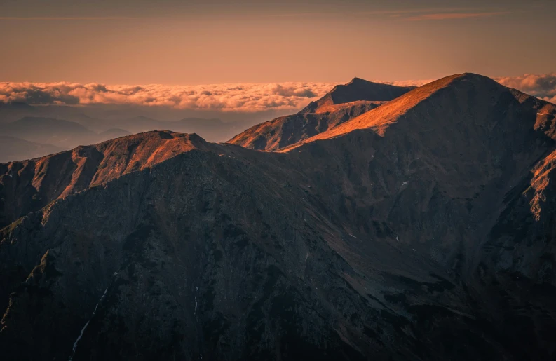 a mountain range with several rocky mountains on one side