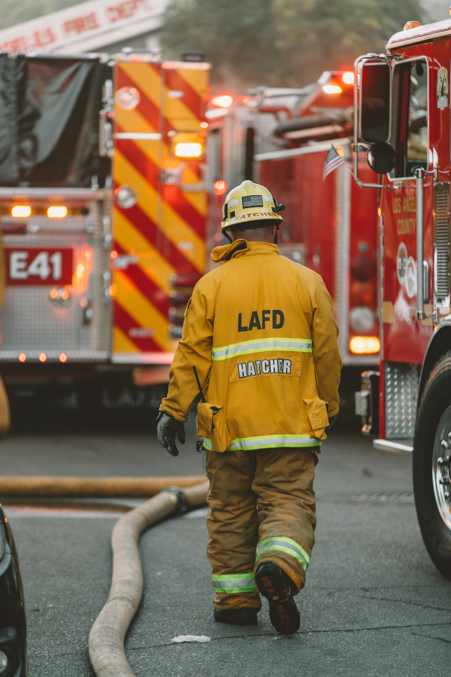 a firefighter walks along the street and talks to the other