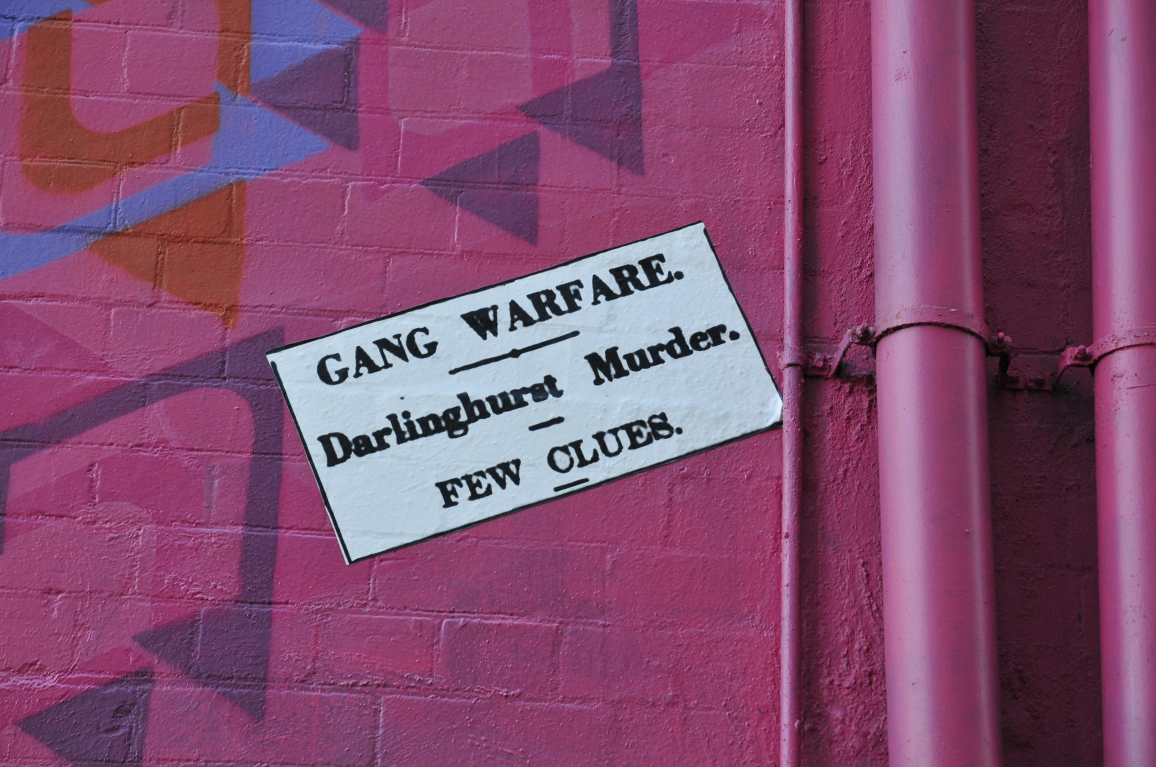 a pink wall with a sign that says gang wars are
