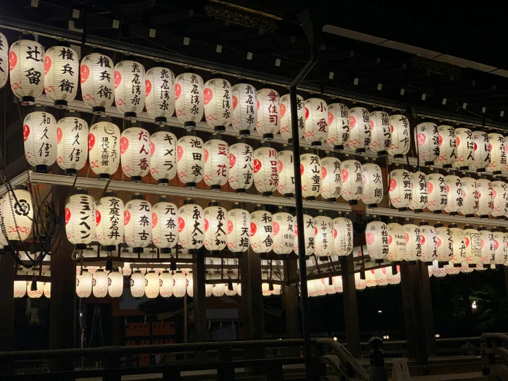a large display of lighted balls with oriental writing