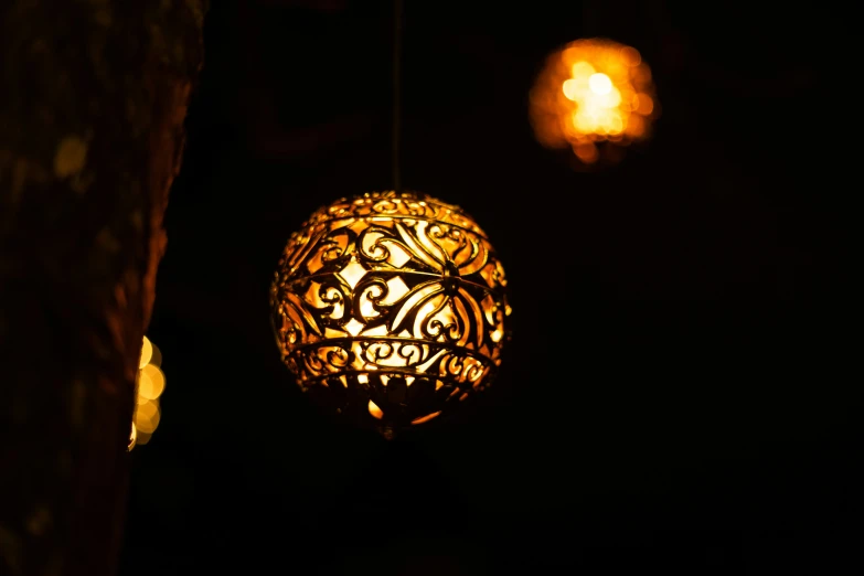 a lamp hanging above a light fixture inside a room