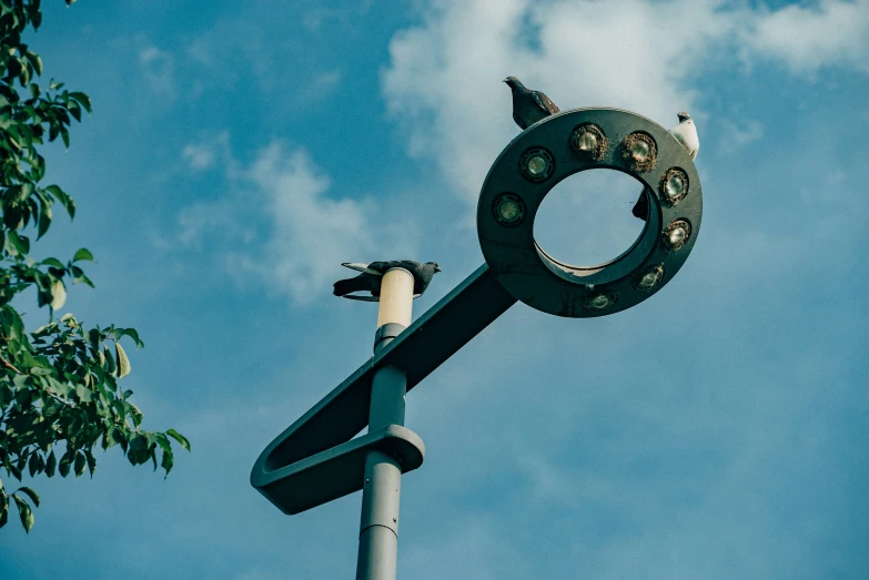 a large metal sculpture mounted to the side of a street light