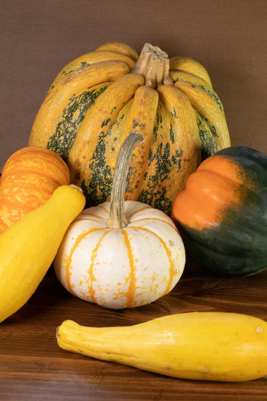 pumpkin, squash and squash on a wooden surface