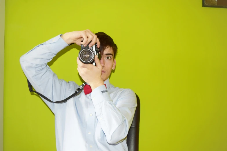 a man with a camera in a room