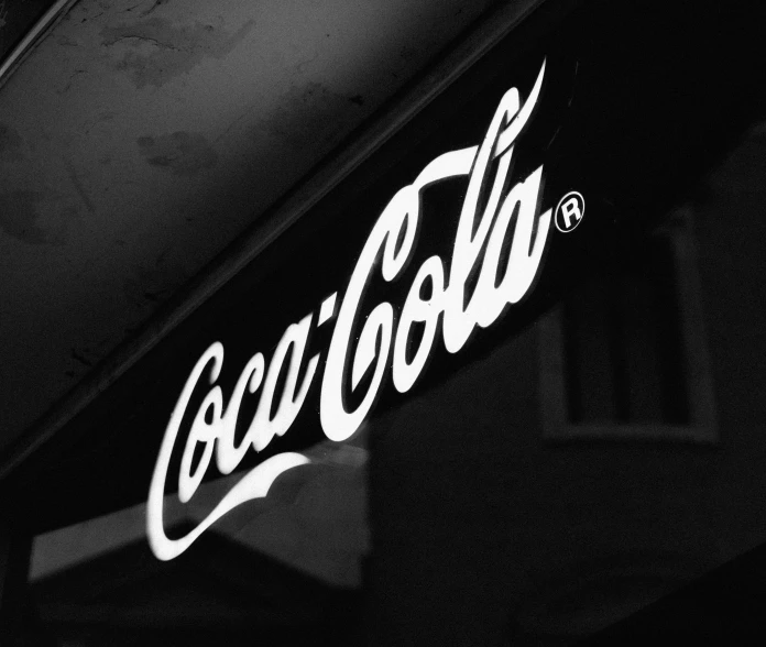 this coca - cola sign is painted black and white