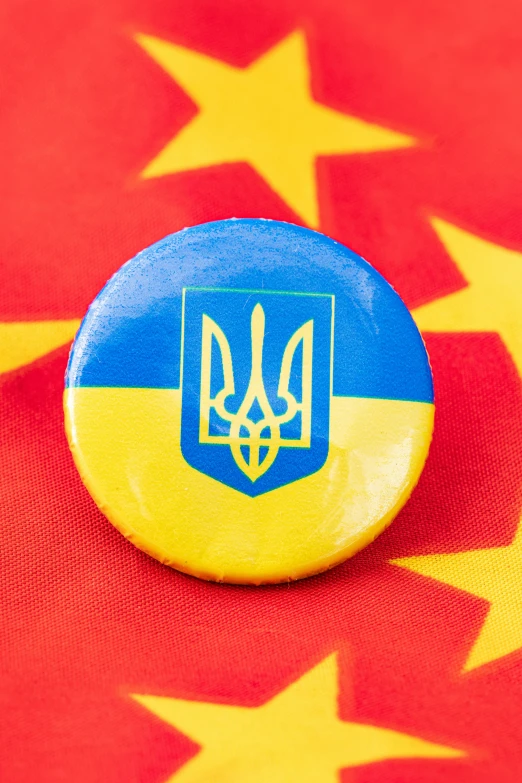 ons with an image of the emblem of ukraine are on a red, yellow and blue background