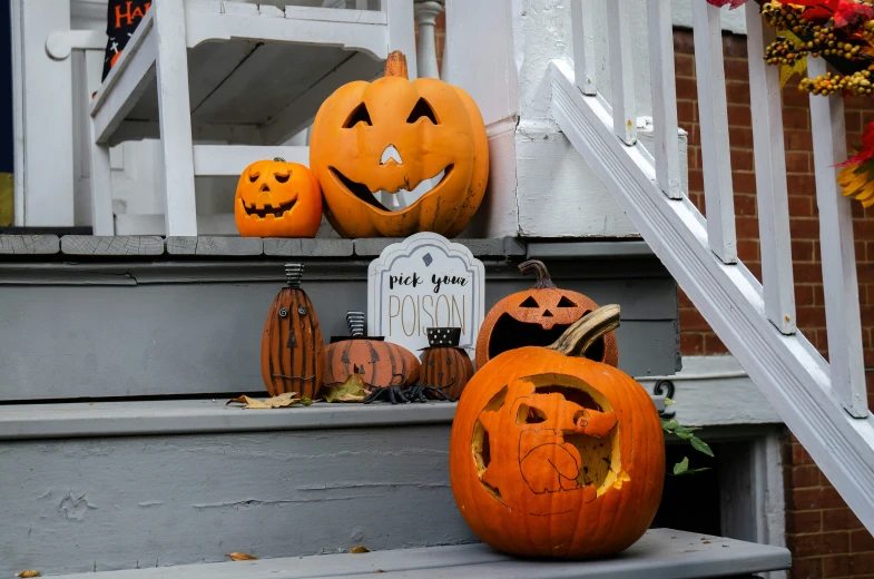 a couple of pumpkins on the steps of a house