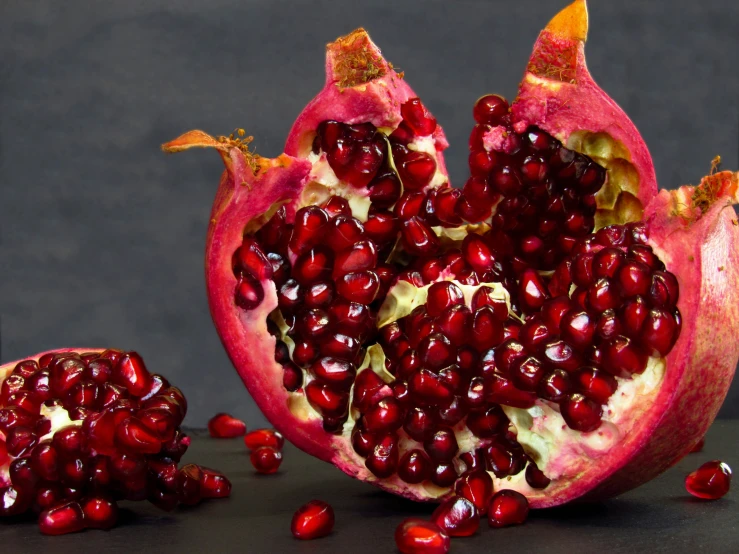 the ripe pomegranate has been cut open and arranged on the table