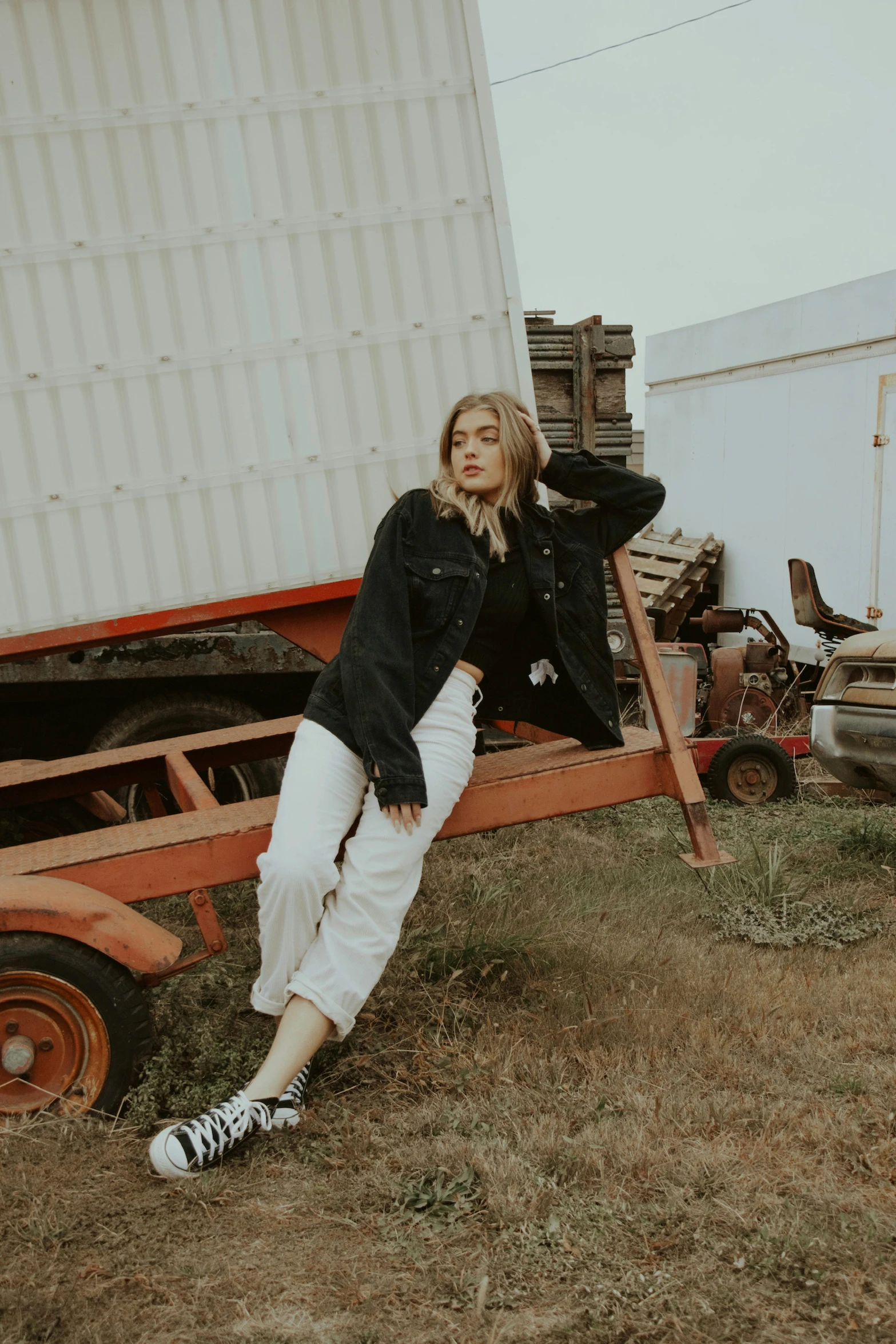 a woman leaning on the back of a trailer