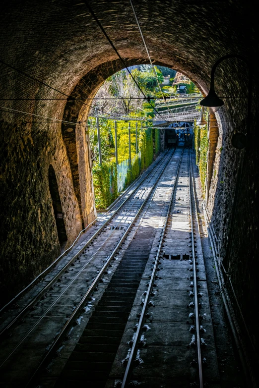 a narrow train tunnel with a train tracks in it