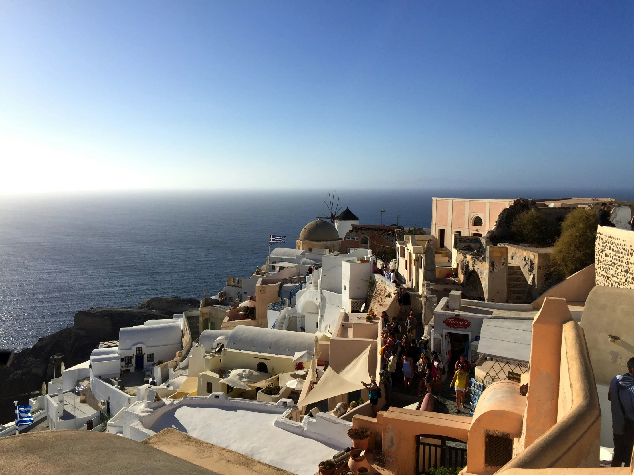 a city on the edge of an ocean by some cliffs