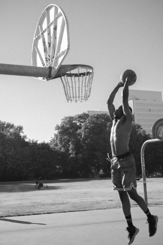 a man jumping up to grab a basketball with his hand