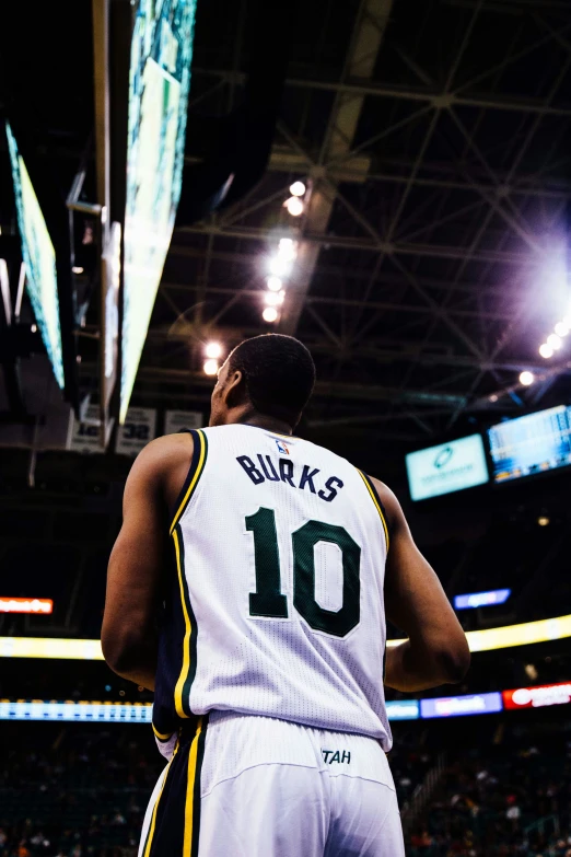 a basketball player looking up with the back turned to the crowd