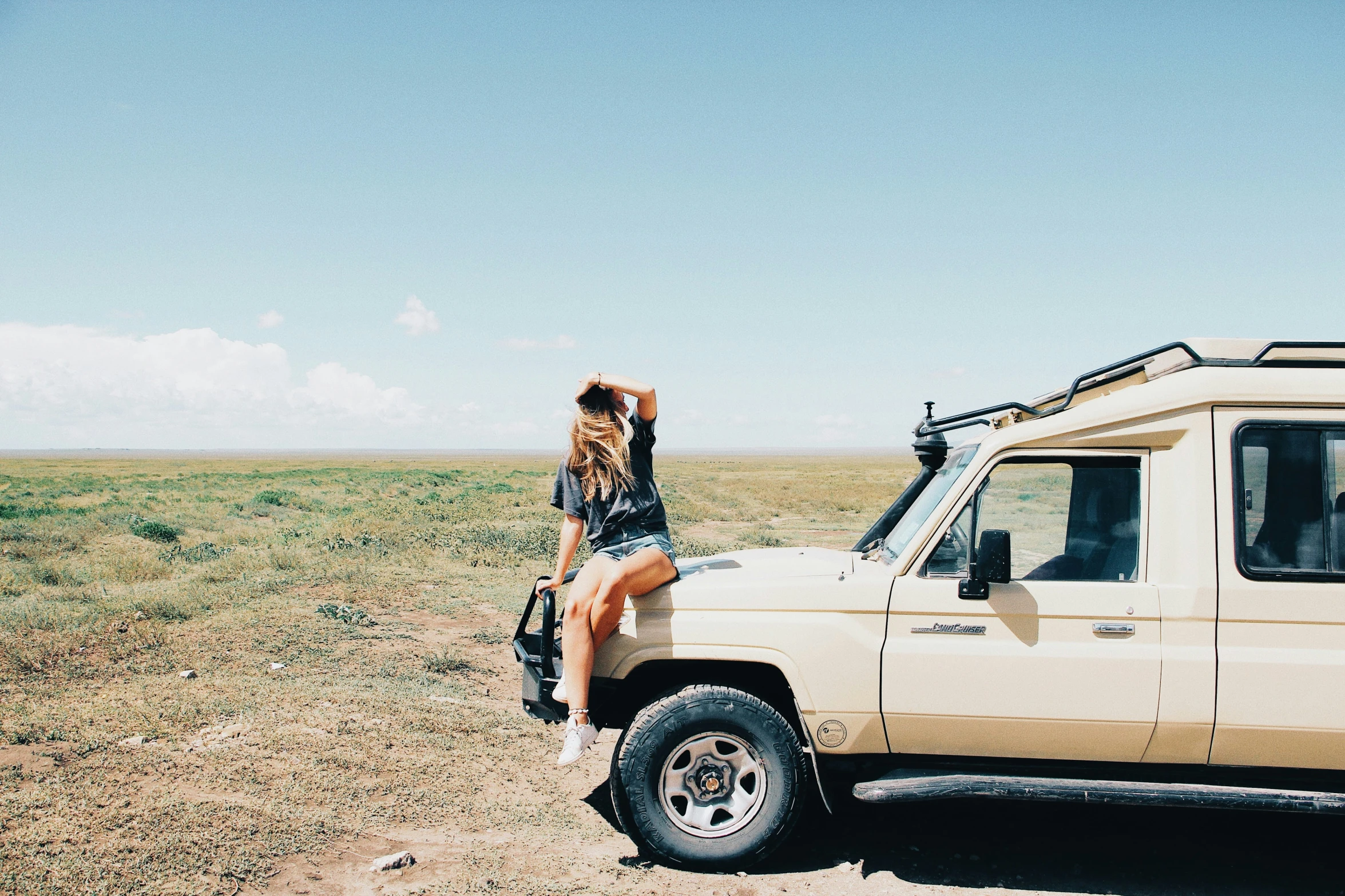 woman looking into the open sky at a truck