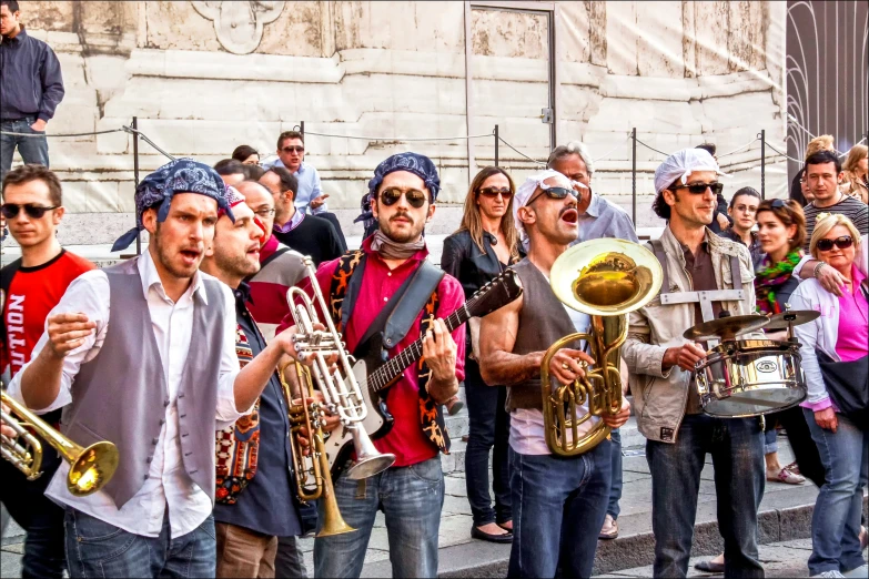 many people are standing on the steps with trumpets