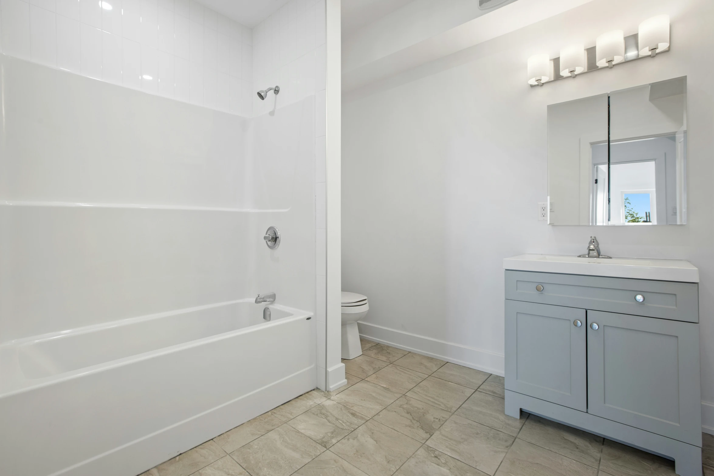 a bathroom is shown with white walls and tile floor