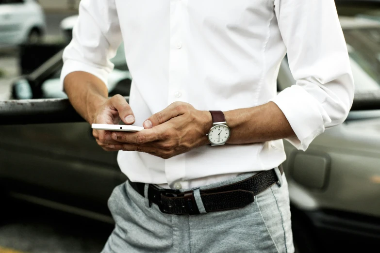 a man in shorts holding a smart phone