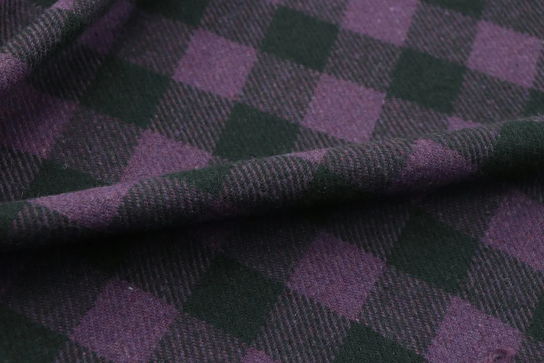 a close up image of a purple and black plaid fabric
